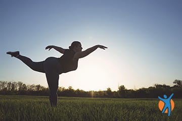 Woman practicing yoga pose outside swan pose Woman practicing yoga outside - use herbal remedies for to reduce knee pain and inflamation