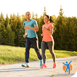 A young couple jogging in the park - learn the benefits of exercise