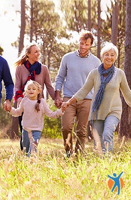 A family walking outside on a sunny day - learn these alternative pain relief therapies