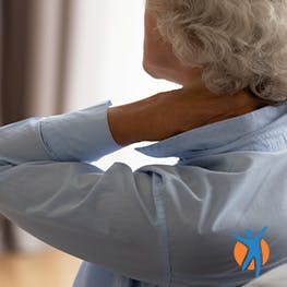 Elderly woman holding her neck in discomfort - get pain relief for osteoarthritis