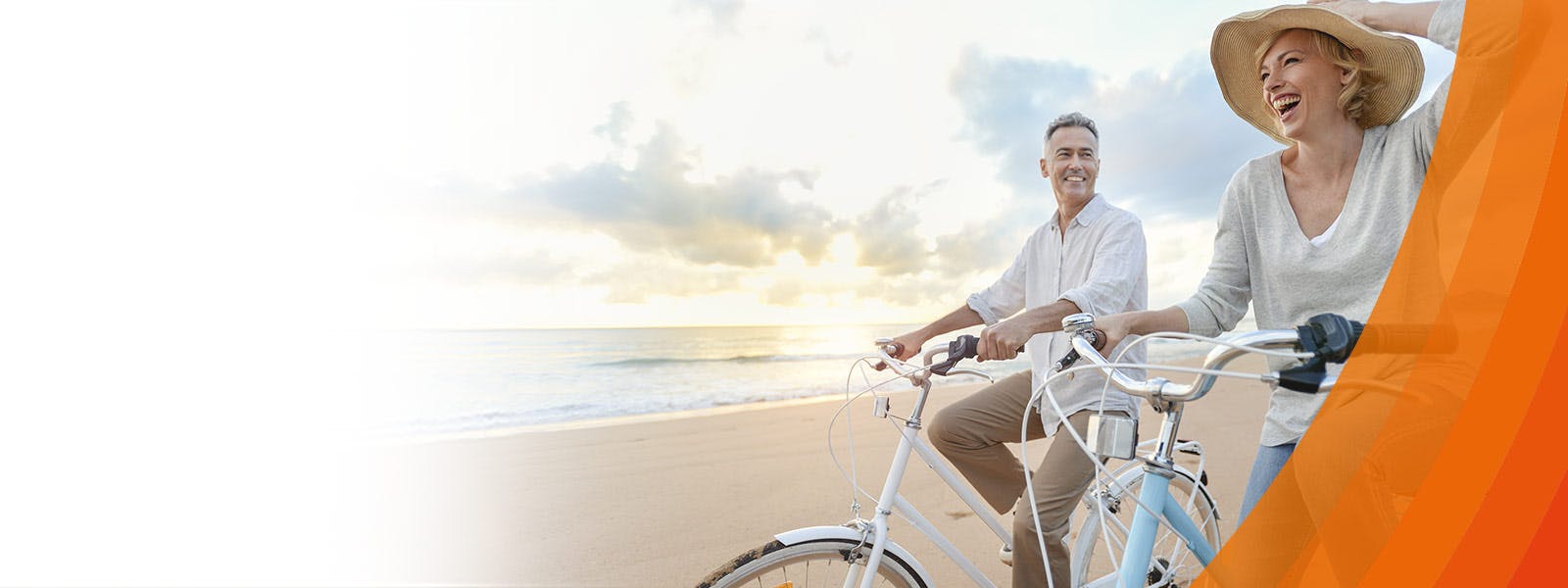 A couple riding their bicycles at the beach - learn about Osteoarthitis, the symptoms and how to relieve them