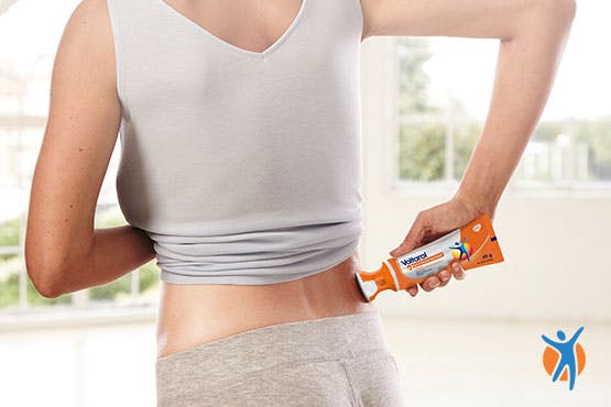 Someone squeezing Voltarol Back & Muscle Pain Relief 1.16% Gel with a No Mess Applicator
