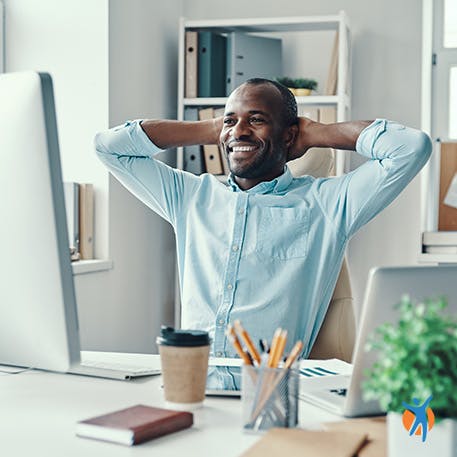 Neck pain relief Man looking relaxed at his computer - learn some home remedies for neck pain