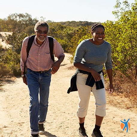 A couple out on a hike - using well-fitting shoes helps avoid ankle pain when walking