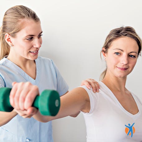 Woman with physical therapist doing exercise to relieve shoulder pains