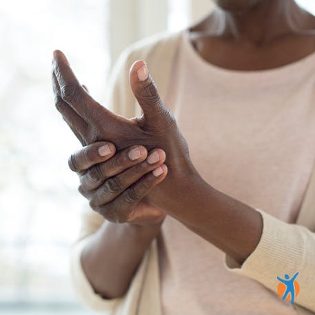 Hand and finger pain self-care methods Woman holding sore wrist