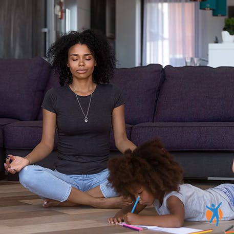 Woman meditating, with daughter playing quietly - learn about mindfulness for sleep