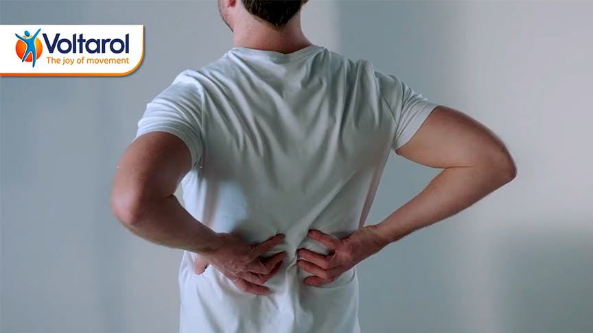 How does you posture affect your back pain? Man holding his back in pain