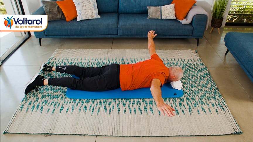 Man lying on his stomach with arms spread