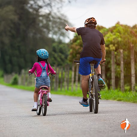 Father and daughter riding a bike