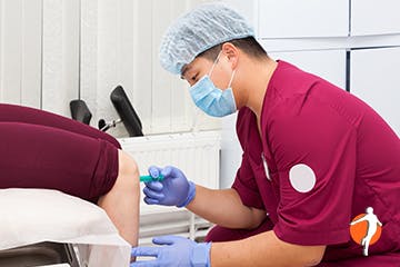 Medical Doctor administering injection for pain relief Medical Doctor administering injection for pain relief