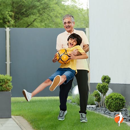 Grandpa and grandson playing in the garden