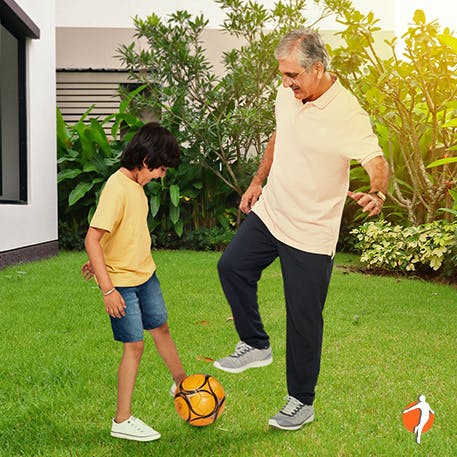 Dad and son playing football