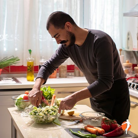 Man preparing salad in the kitchen