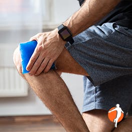 Man holds ice pack on knee