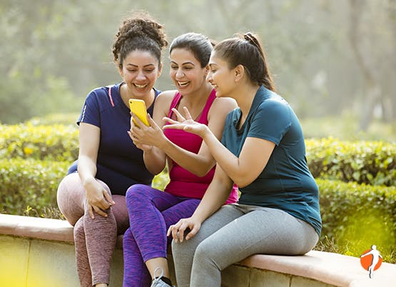 Group of women happily interacting with the phone