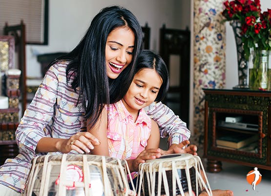 Mother and daughter playing the drums