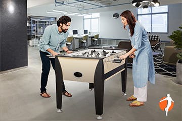 Being with family Man and woman playing table soccer
