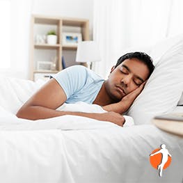 Ways to sleep to avoid neck pain Man sleeping in bed