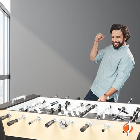 Man  celebrating his victory in table football