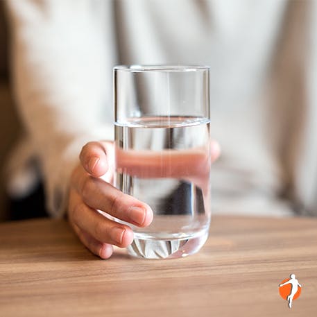 A person holding a glass of water