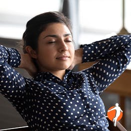 Woman sitting relaxed with her hand behind her head