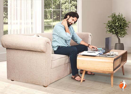 A man with a laptop working from home and neck pain 