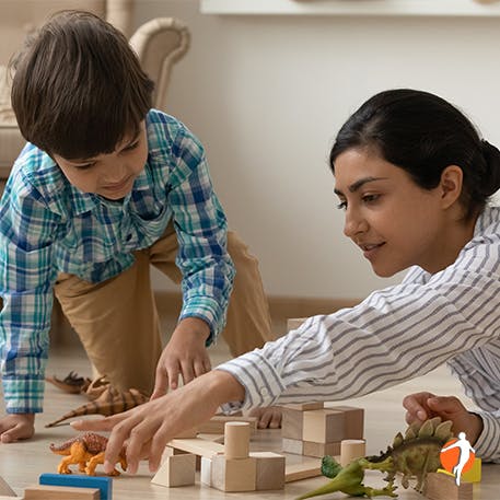 Mother playing with her son and his toys