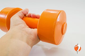 A hand holding a dumbbell for wrist curl exercises