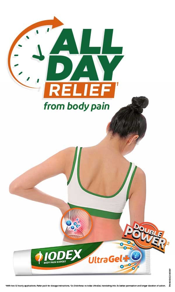 A girl holding her lower back in pain A girl holding her lower back in pain