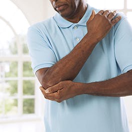 Man experiences joint pain elbow pain
