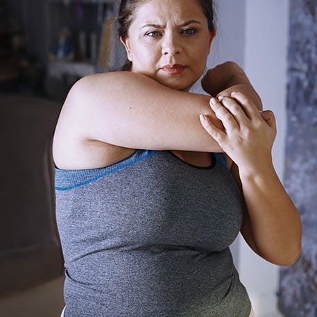 A woman stretching her arm before exercise A woman stretching her arm before exercise
