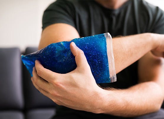 Icing your joints to help with Osteoarthritis pain Man icing his elbow