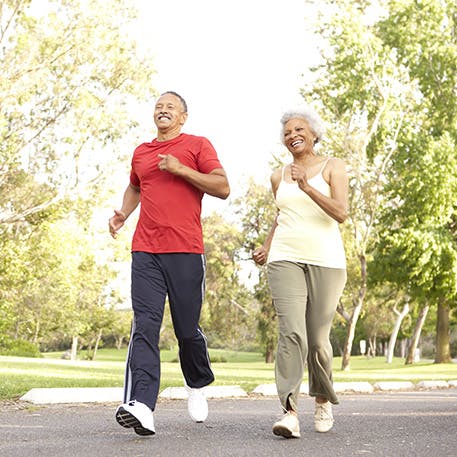 Elderly couple jogging in the park
