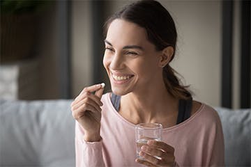 woman using a pain relief tablet