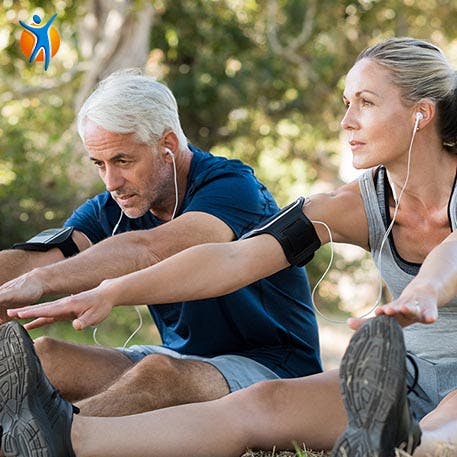 A man and women stretching their backs in the garden 