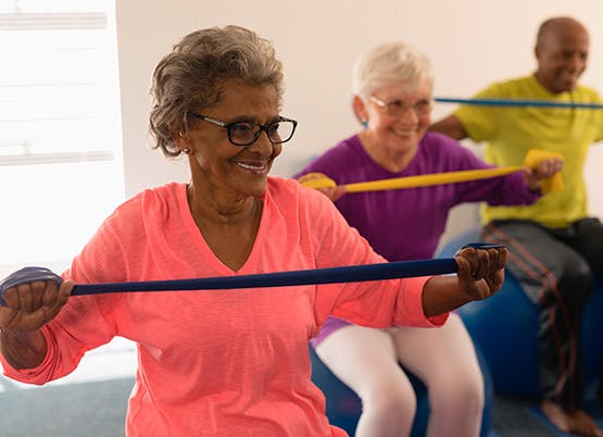 Group of eldery ladies doing exercise with stretchy exercise bands