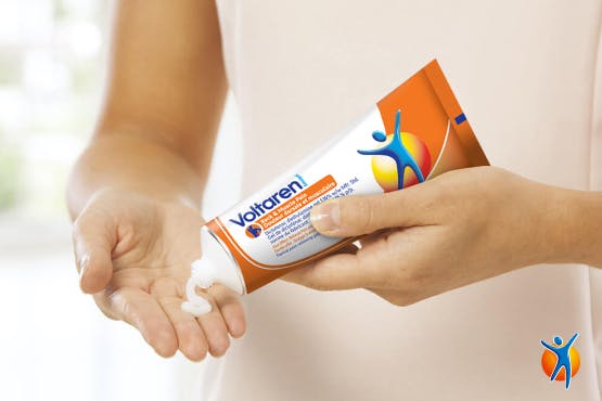 Person squeezing Voltaren pain relief gel into their hand