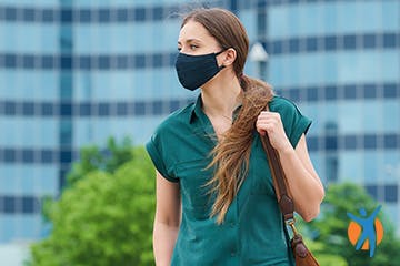 Woman standing outside with face mask on