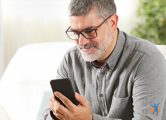 Man navigating the Voltarol website using head gestures and his mobile phone