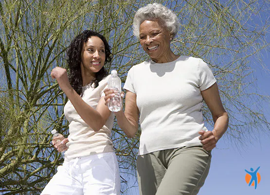 Two women outside, experiencing the pain relief benefits of walking