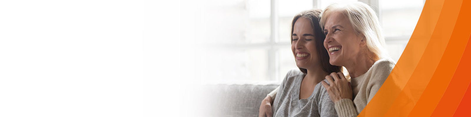 Two women sitting and smiling