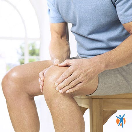 Man holding his knee from arthritis pain
