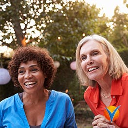 three women smiling outside