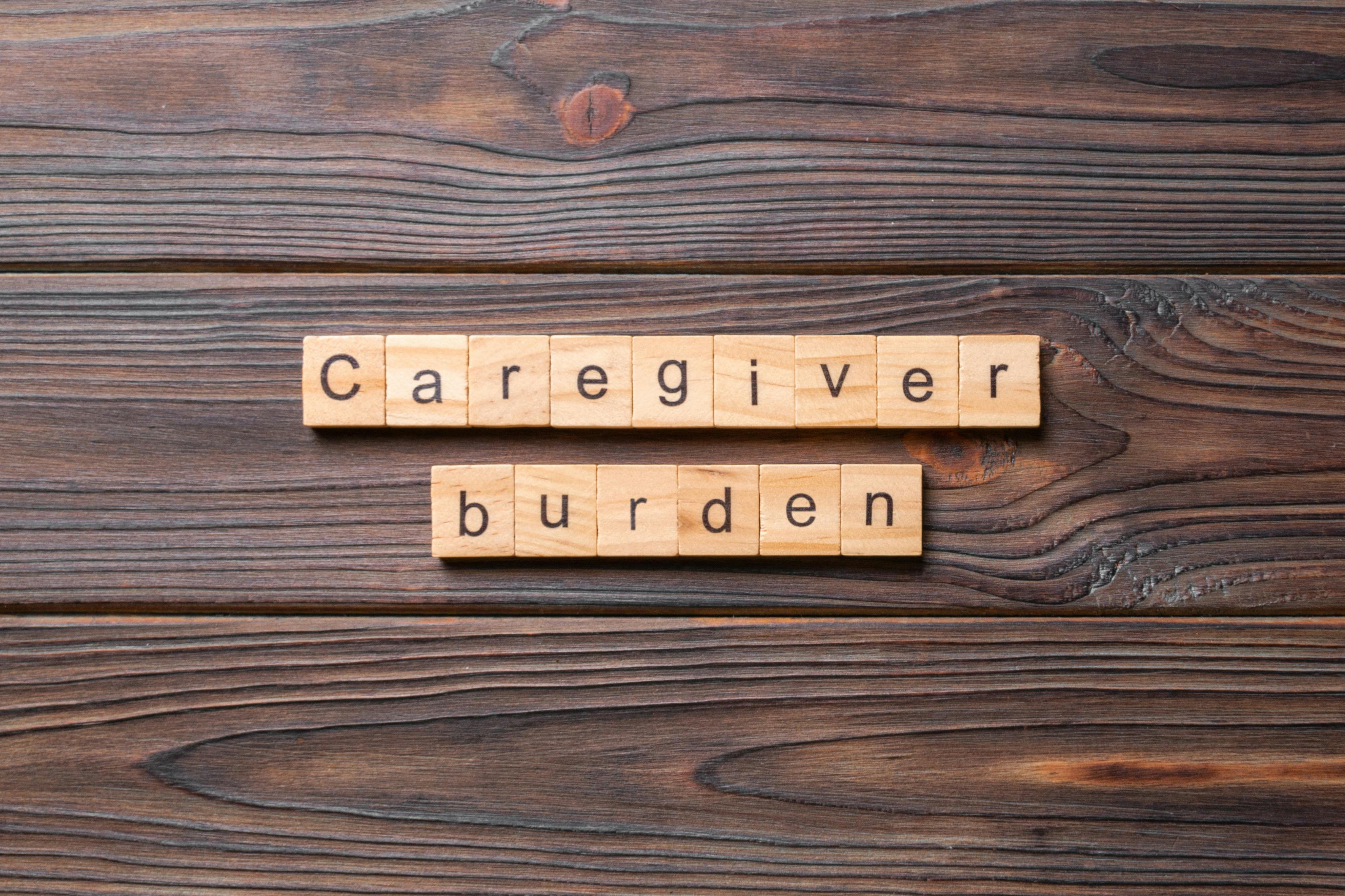 Wooden letters on table spelling out the words caregiver burden