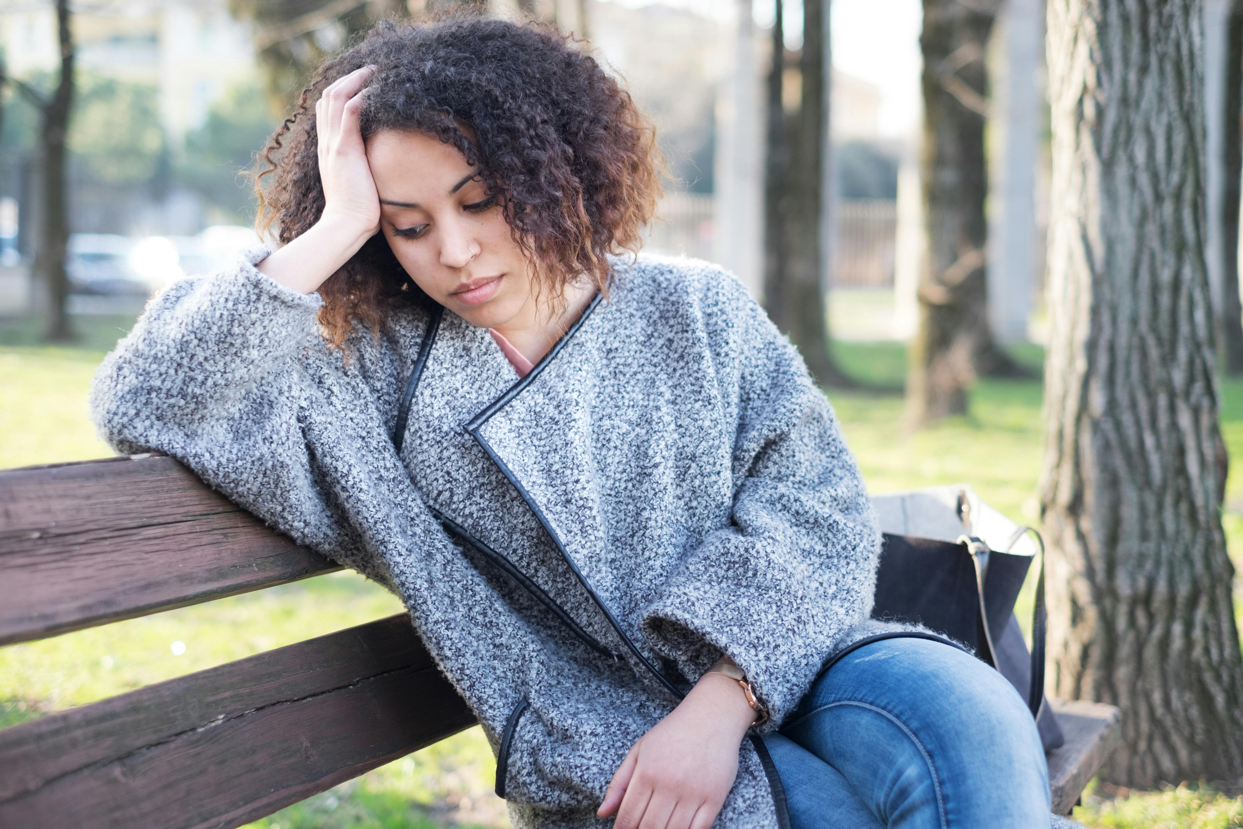 tired caregiver leaning against a wall