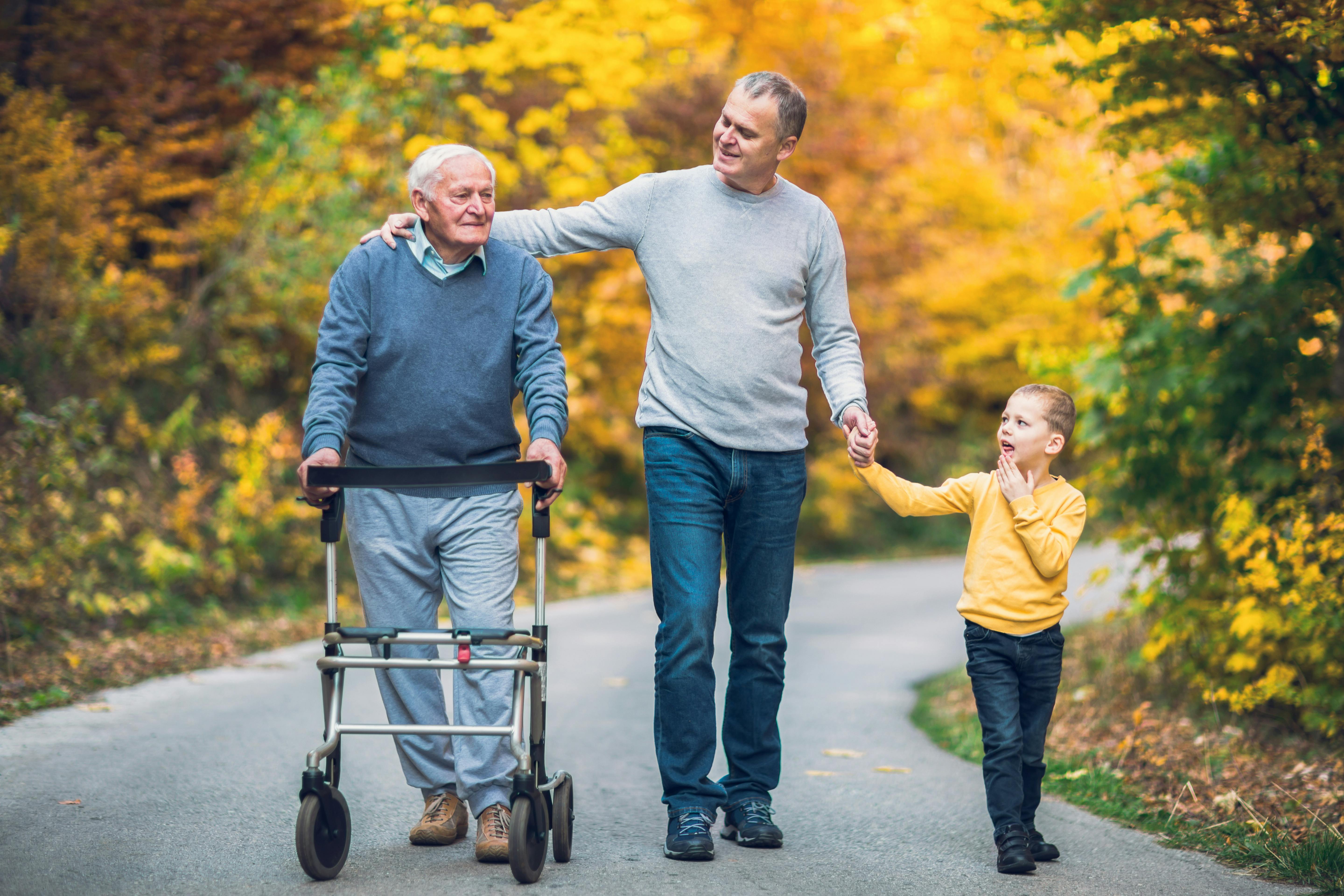 Elderly father adult son and grandson out for a walk