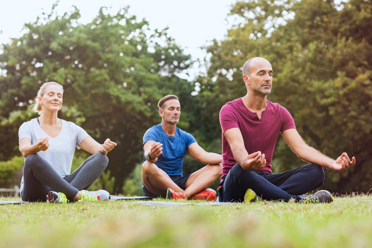 Group of adults practicing mindfulness outside