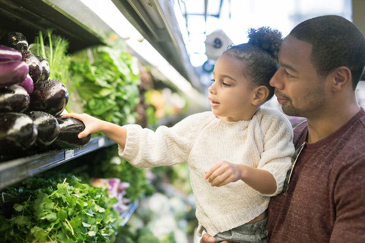 Father and daughter looking at plants