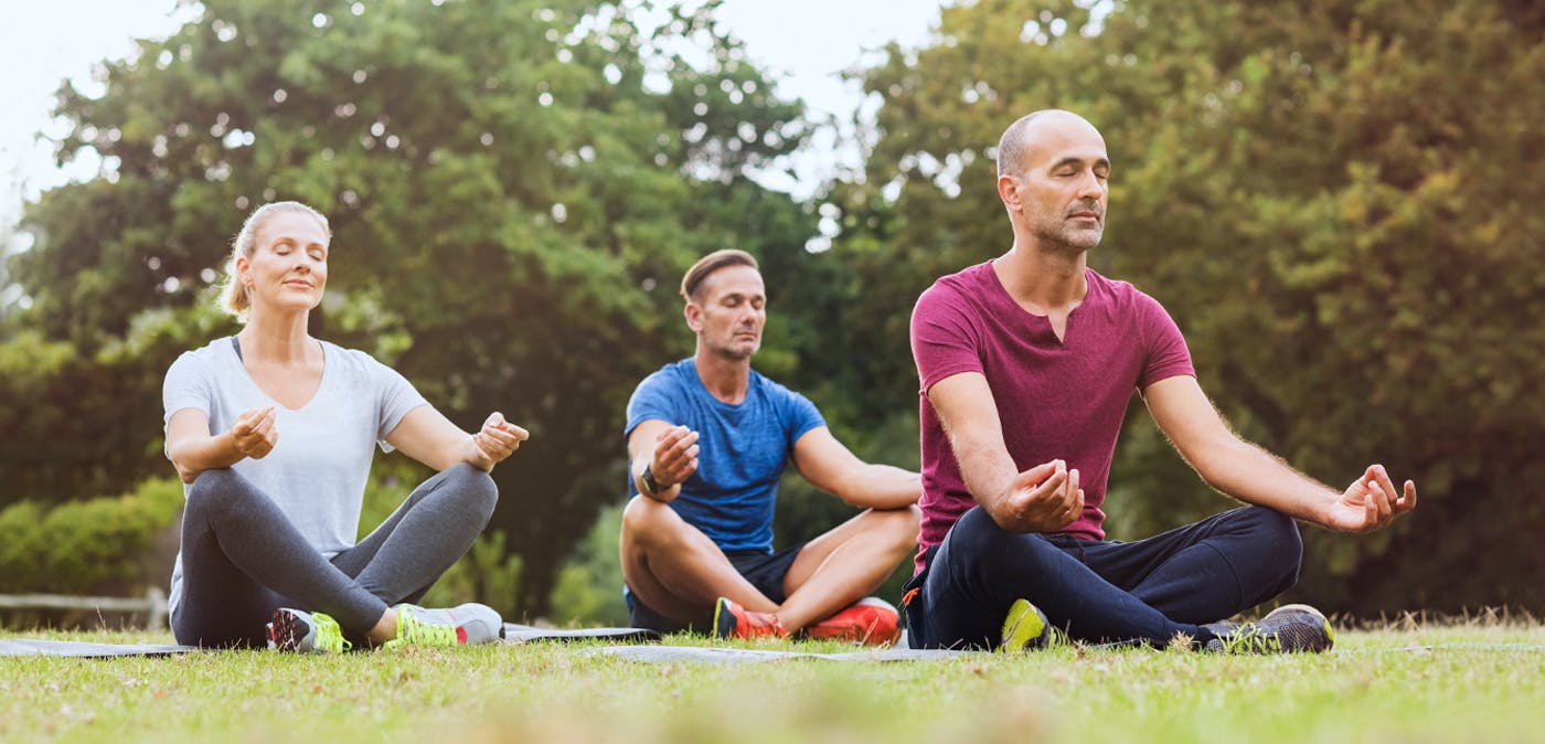 Group of adults practicing mindfulness outside